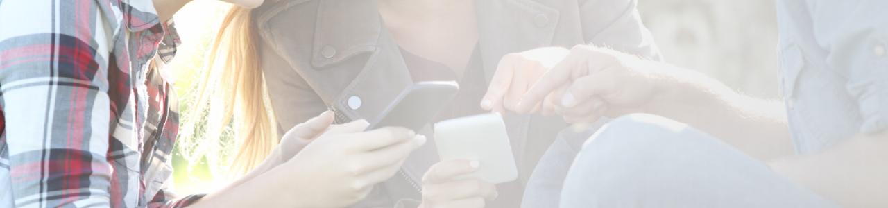 the image of a group of people looking at their cell phones