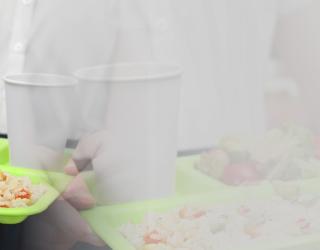 girl with a tray with food in the school restaurant.