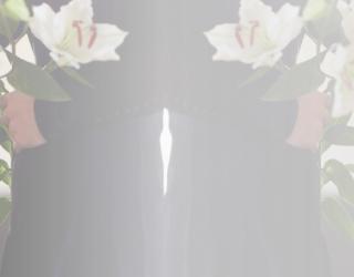 the image contains a person in a funeral home with bouquets of flowers