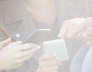 the image of a group of people looking at their cell phones